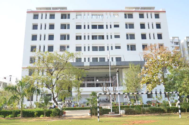 A building and the green grounds of the SKIT Jaipur campus