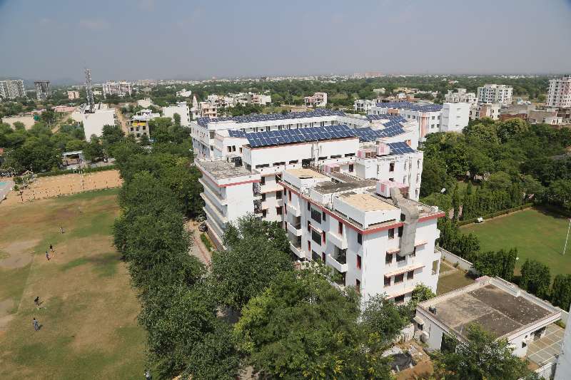 A building and the green grounds of the SKIT Jaipur campus