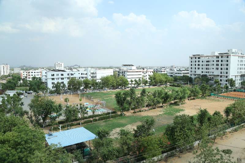 A building and the green grounds of the SKIT Jaipur campus