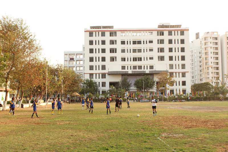 A building and the green grounds of the SKIT Jaipur campus